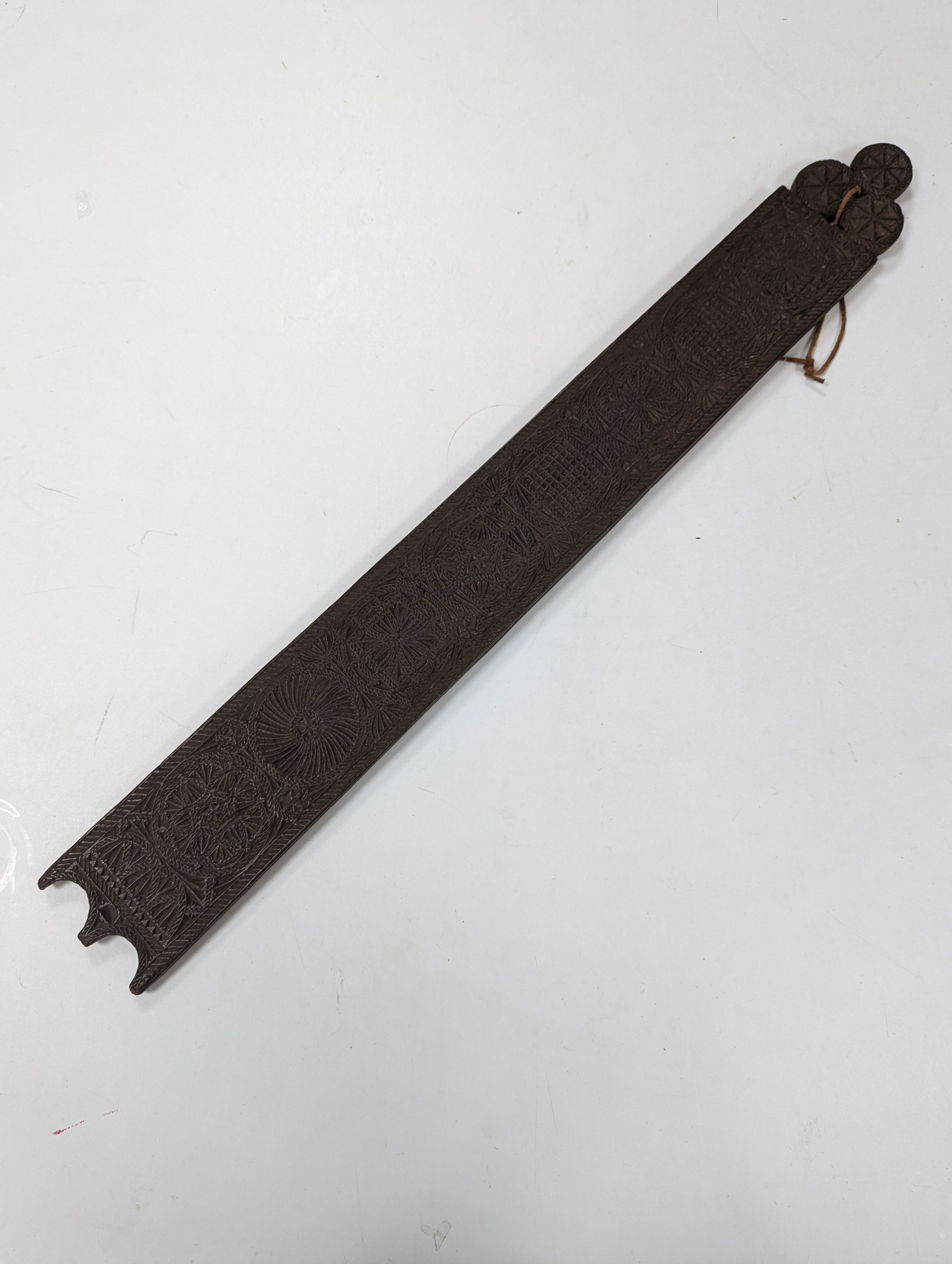 An 18th century Norwegian chip carved oak mangle board, dated 1730, 77cm